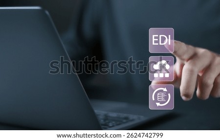 EDI Electronic Data Interchange concept. Platform for exchanging business documents between organizations. Person using laptop with EDI icons on virtual screen.