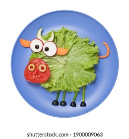 Edible Bull Made Of Vegetables. Funny Food. Creative Cooking Idea For Kids. Play With Food. Isolated On Blue Plate On White Background.