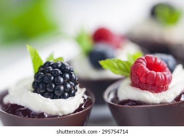 Edible Chocolate Cup Filled With Gelatin And Whipped Cream And Topped With Fresh Berry And Mint Leaf On The White Background Close Up Horizontal