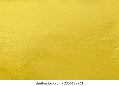 Edible gold leaf sheet as background, closeup