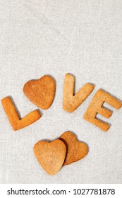 Edible letters of the word love. Shortbread cookies in the form hearts and letters. Vertical format with copy space.