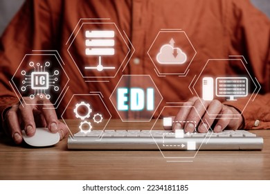 EDI-electronic data interchange concept, Person using computer on office desk with virtual screen EDI icon.