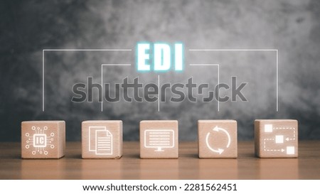 EDI-electronic data interchange concept, Wooden cube block with virtual screen EDI icon on wooden desk.