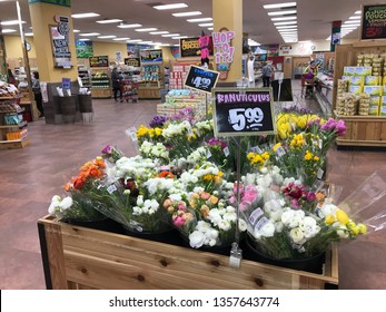 Edina, MN/USA. April 2, 2019. The interior of a Trader Joe’s grocery store with ranunculus flowers prominently displayed.