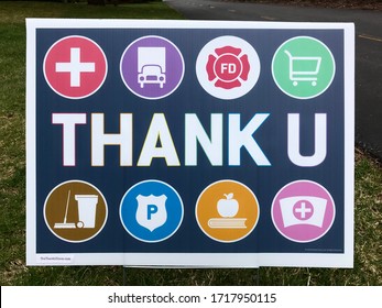 Edina, MN/USA. April 29, 2020. A Thank You sign is displayed near a residential walkway. It is thanking essential workers such as nurses, police, grocery clerks & firefighters during the pandemic.