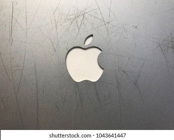 Edina, MN/USA- March 1, 2018. Top of an old gray Apple laptop that is completely scratched up.