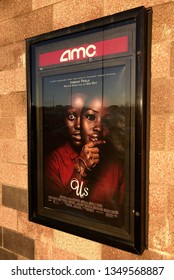 Edina, MN/USA. March 22, 2019. The exterior of the AMC Movie theater in Minneapolis featuring a display of current box office hit film Us in theaters now.
