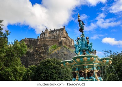 Edinburgh Castle in blue sky and clouds and Ross Fountain