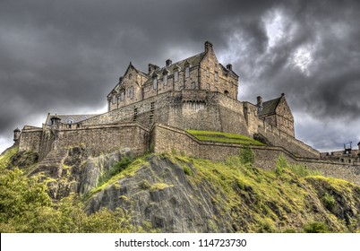 Edinburgh Castle on Castle Rock in Edinburgh, Scotland, UK against dark rainclouds
