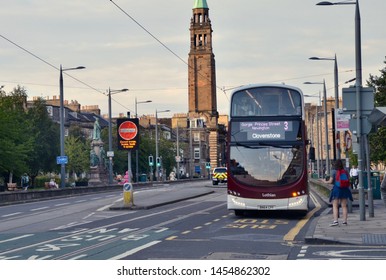 Edinburgh city centre bus travelling along the Greenways. Traffic reduction measures to reduce carbon emissions from city vehicles. Tourist waiting at bus stop. Edinburgh city, scotland UK. jULY 2019