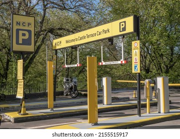 Edinburgh City Centre, Scotland, Great Britain, UK - May 11th 2022: Castle Terrace NCP car parking lot ticket dispenser, pay, barrier, vehicle max height entrance point.