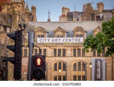 Edinburgh City Centre, Scotland, Great Britain, UK - May 11th 2022: View of City Art Centre from Princes Street Road with blurred foreground traffic lights.