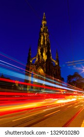 Edinburgh at night scene with Lights streak from high-sided vehicles on Princess street and Scott Monument on background
