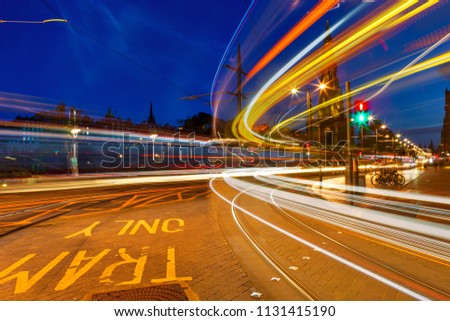 Edinburgh at night scene with Lights streak from high-sided vehicles on Princess street and Scott Monument on background