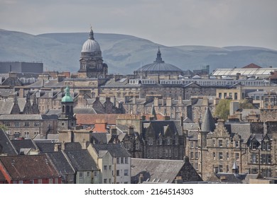 Edinburgh Scotland 01 June 2021: Old and modern rooftops over city centre with Pentland Hills in background