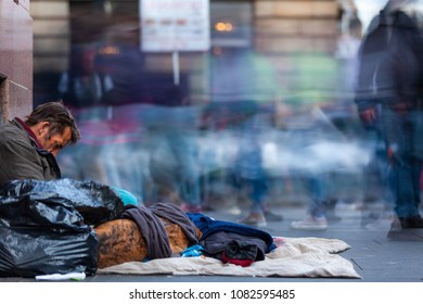 EDINBURGH, SCOTLAND - AUG 26, 2012: Unidentified local homeless white man sits on pavement in the city of Edinburgh on the Royal mile.