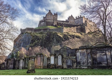 Edinburgh, Scotland - January 17, 2020: Old graves on a graveyard next to Saint Cuthbert Church and castle in Edinburgh city