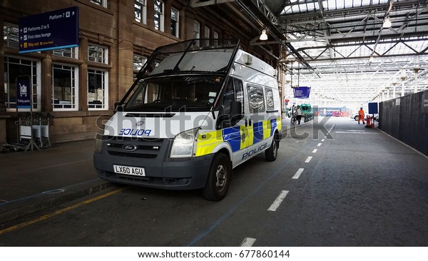 EDINBURGH, SCOTLAND - JUNE 19, 2017\
: Edinburgh Waverley railway station. Police Vehicle responds to an\
emergency on a city center street during special\
event.