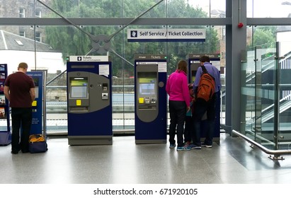 EDINBURGH, SCOTLAND - JUNE 20, 2017 : Unidentified Travellers People Buy Train Tickets From Vending Machine At Haymarket Railway Station In Edinburgh, Scotland, UK.