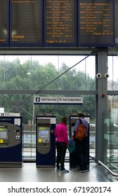 EDINBURGH, SCOTLAND - JUNE 20, 2017 : Unidentified Travellers People Buy Train Tickets From Vending Machine At Haymarket Railway Station In Edinburgh, Scotland, UK.