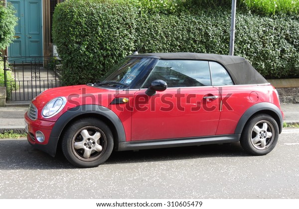 EDINBURGH,\
SCOTLAND, UK - CIRCA AUGUST 2015: red Mini Cooper car (new model,\
produced from 2013 onwards) with black\
roof
