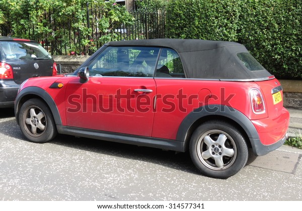 EDINBURGH,\
SCOTLAND, UK - CIRCA AUGUST 2015: red Mini Cooper car (new model,\
produced from 2013 onwards) with black\
roof