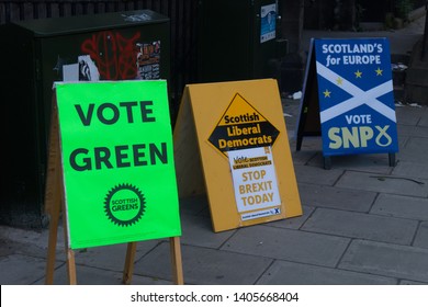 Edinburgh, Scotland / United Kingdom - May 23rd 2019: Signs for the Green Party, The Liberal Democrats and the Scottish National Party in front of a polling station during the European Elections 2019
