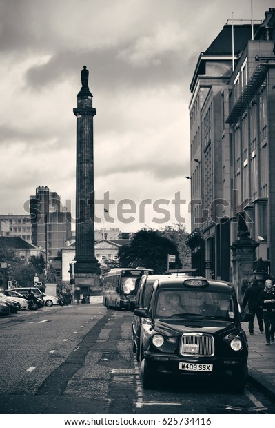 EDINBURGH, UK -\
OCT 8: City street view with traffic on October 8, 2013 in\
Edinburgh. As the capital city of Scotland, it is the largest\
financial centre after London in the\
UK.