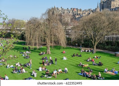 Edinburgh, United Kingdom. 8 April 2017 : People sitting, laying and relaxing in Princes Street Gardens, the public space in city center of Edinburgh.