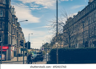 Edinburgh, United Kingdom. April 13, 2017. The Bus And The Car Driving And The Man Cycling On The Elm Row Road, Edinburgh, Scotland, United Kingdom