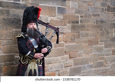 EDINBURGH,UK - AUGUST 14,2019 : Bagpipe player in traditional scottish kilts in Edinburgh