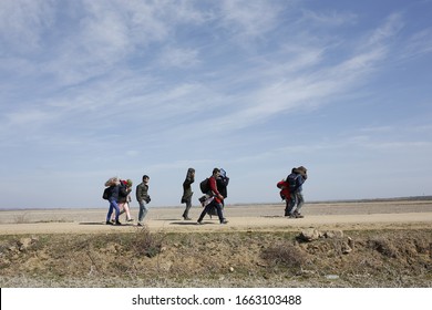 EDIRNE, TURKEY - MARCH 04, 2020: Migrants walk on a road in Edirne. Turkey will no longer close its border gates to refugees who want to go to Europe
