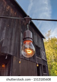 Edison Bulb String Lights In Front  Of Barn And Sky.