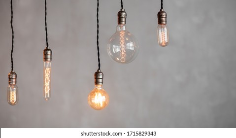 Edison lamp is included in loft room, against background of concrete wall. - Powered by Shutterstock