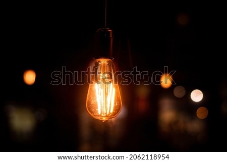 Edison vintage retro electric light bulb on dark background