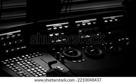 Edit video production control panel in studio. Editor editing and grade film in movie post room. Telecine control machine and man hand editing or adjusting color on digital video in post production.
