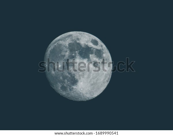 Edited version of the full moon with black\
sky in the background.