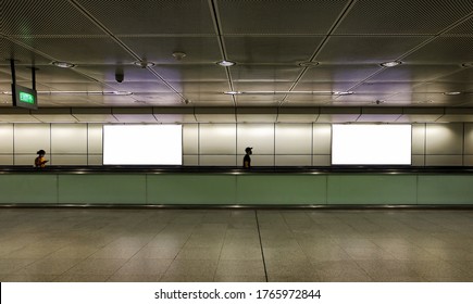 Edited Visual For Advertising Billboard Display: Pedestrians Walking On Moving Walkway / Travelator In Train Station. Blank Billboards Advertising Space For Mock Up Purpose; OOH Ad Placement.