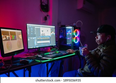 Editor man video editing and color list grading and enjoying with coffee in the house studio this is lifestyles of freelancer - Shutterstock ID 1895036935