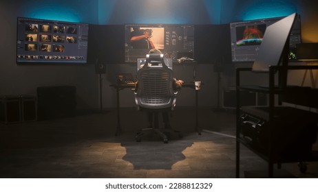 The editor works in studio on computer, edits video, makes color correction for movie post production. Big screens showing color grading program interface with film footage, RGB graphic and levels. - Shutterstock ID 2288812329