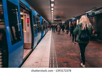 Editorial 03.27.2019 Stockholm Sweden. Passengers Walking On The Platform At Gärdet With A Subway Train Waiting With The Doors Open