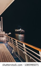 Editorial 03.29.2019 Mariehamn Åland. MS Mariella Seen In The Dark Night From The Deck Of MS Silja Symphony Outside Mariehamn