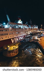 Editorial 03.29.2019 Mariehamn Åland. MS Rosella Moored In The Empty Port At Night Seen From The Leaving MS Silja Symphony