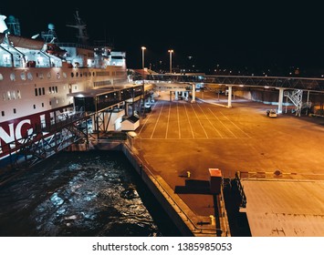 Editorial 03.29.2019 Mariehamn Åland. MS Rosella Moored In The Empty Port At Night Seen From The Leaving MS Silja Symphony