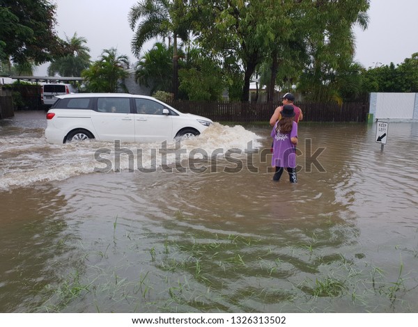 editorial. Car driving through flooded street.\
Townsville, Australia- February 4, 2019. Largest flooding recorded\
in 100 years. Over twenty thousand homes flooded. Thousands\
evacuated from their\
hom