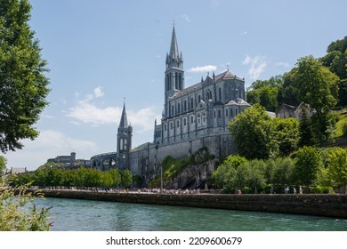 Editorial. July, 2022. Lourdes, France. View Of The River Gave De Pau And The Basilica Of The Holy Rosary In Lourdes, France. The Sanctuary At Lourdes. 