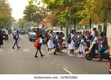 Editorial Traffic Cop Policeman Pedestrian Crossing. Children Go To School In The Morning In White Clothes. Transport On The Road. Sri Lanka, Negombo, 2020.