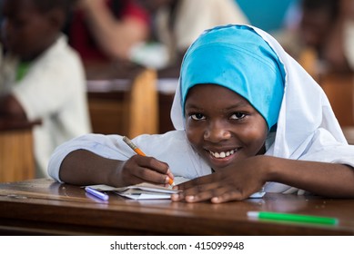 Editorial Use: Girl at school in Zanzibar, Tanzania, 04.2016. Children face tremendously poor life conditions in Africa but the interest in education is high. They are curious, witty and smart.