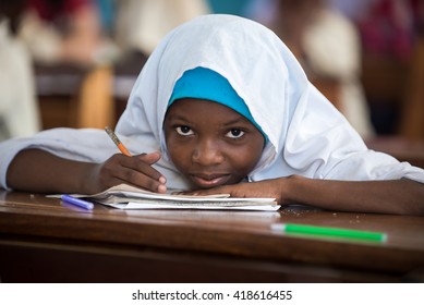 Editorial Use: Girl at school in Zanzibar, Tanzania, 04.2016. Children face tremendously poor life conditions in Africa but the interest in education is high. They are curious, witty and smart.