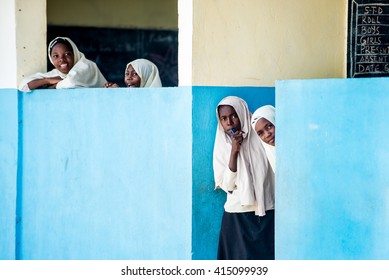 Editorial Use: Girls At School In Zanzibar, Tanzania, 04.2016. Children Face Tremendously Poor Life Conditions In Africa But The Interest In Education Is High. They Are Curious, Witty And Smart.